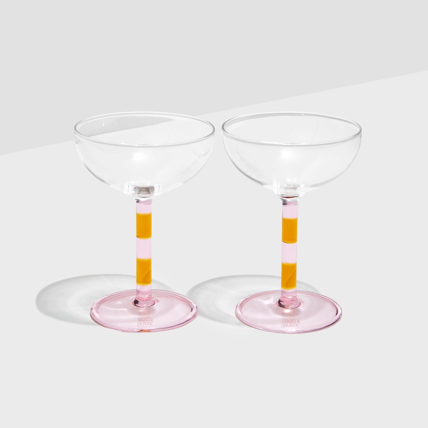 Shop Now STRIPED COUPE GLASSES - PINK + AMBER - SET OF 2 at Fazeek